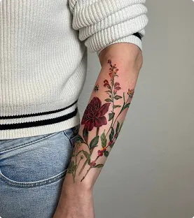 Red rose tattoo on the forearm