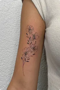 Fine-line cherry blossom tattoo on the forearm