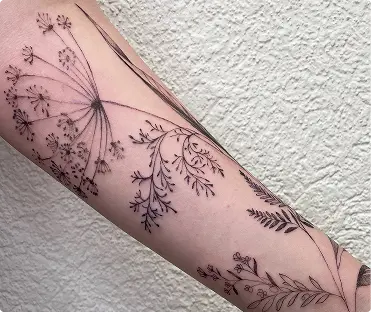 Fine-line wildflower tattoo on the forearm