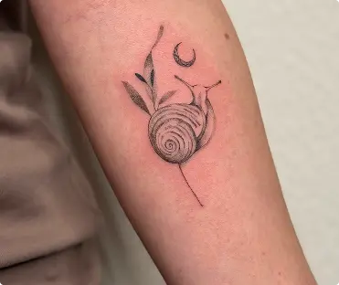 Fine-line snail and moon tattoo on the forearm