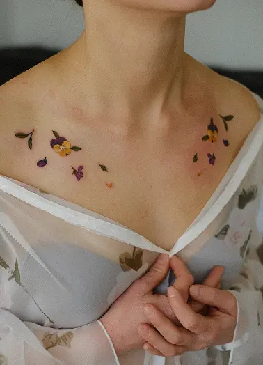 Healed floral tattoo on the collarbone, example of proper aftercare